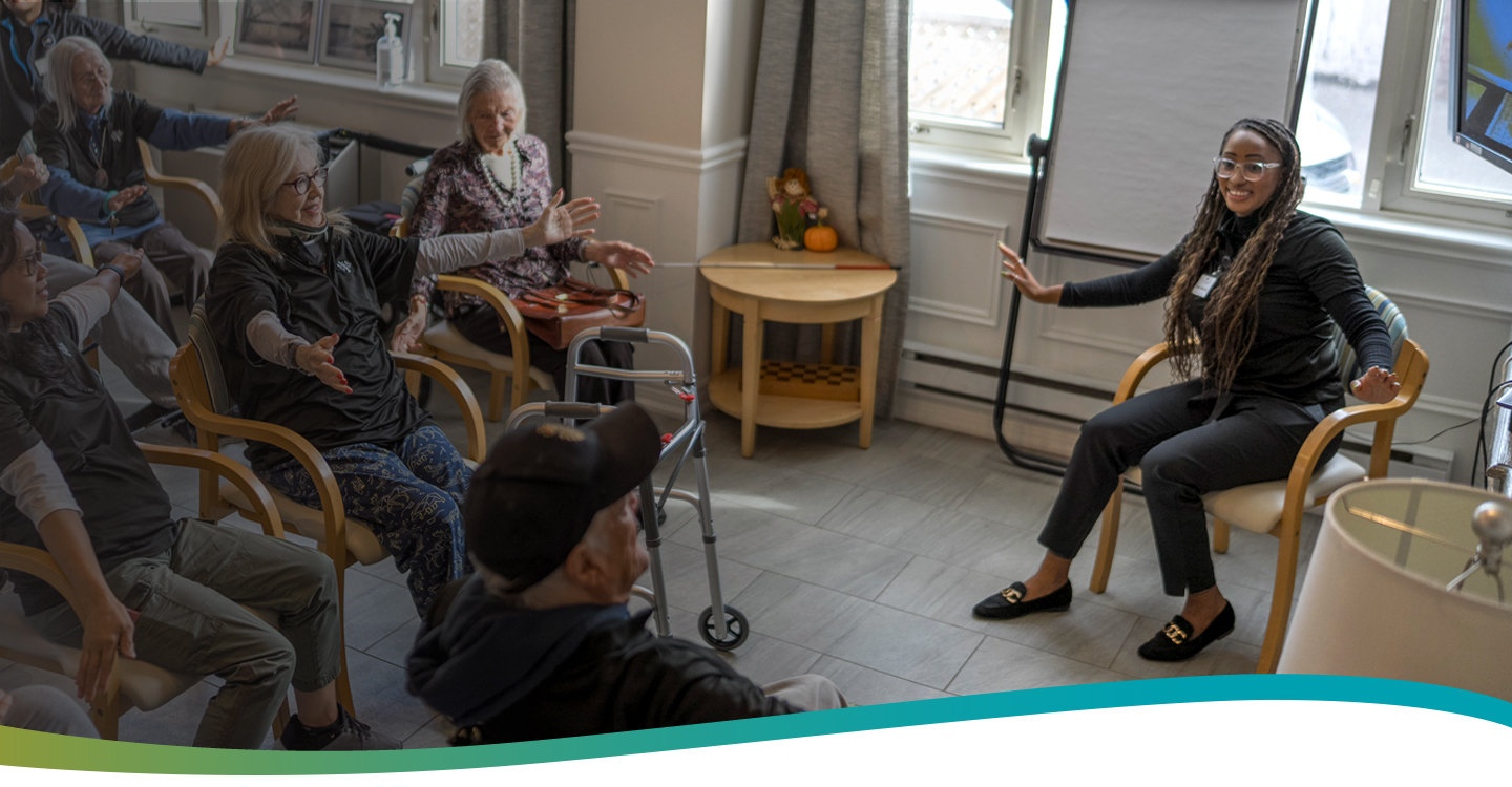 Life Enrichment Director engaging residents in a group exercise activity at Atrium Retirement