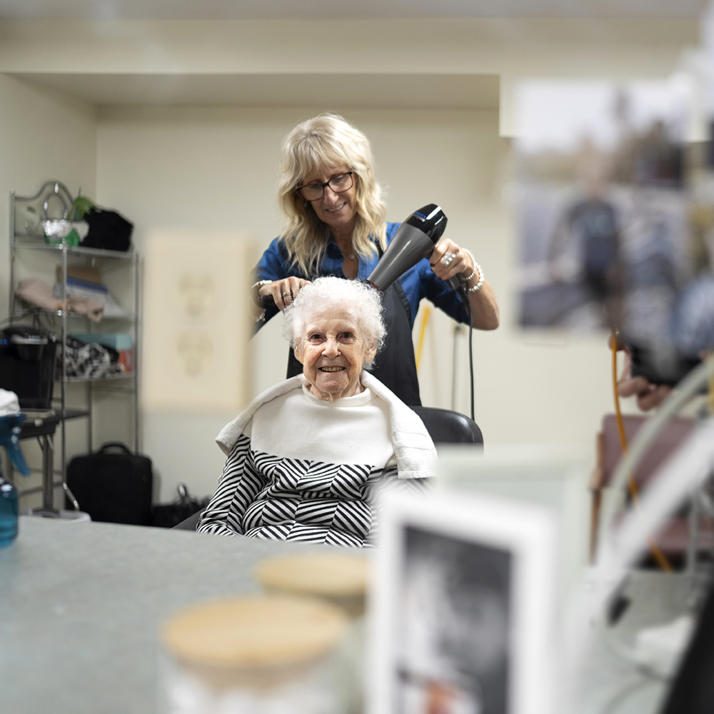 Resident enjoying a relaxing hair appointment at the on-site salon at Atrium Retirement Residence
